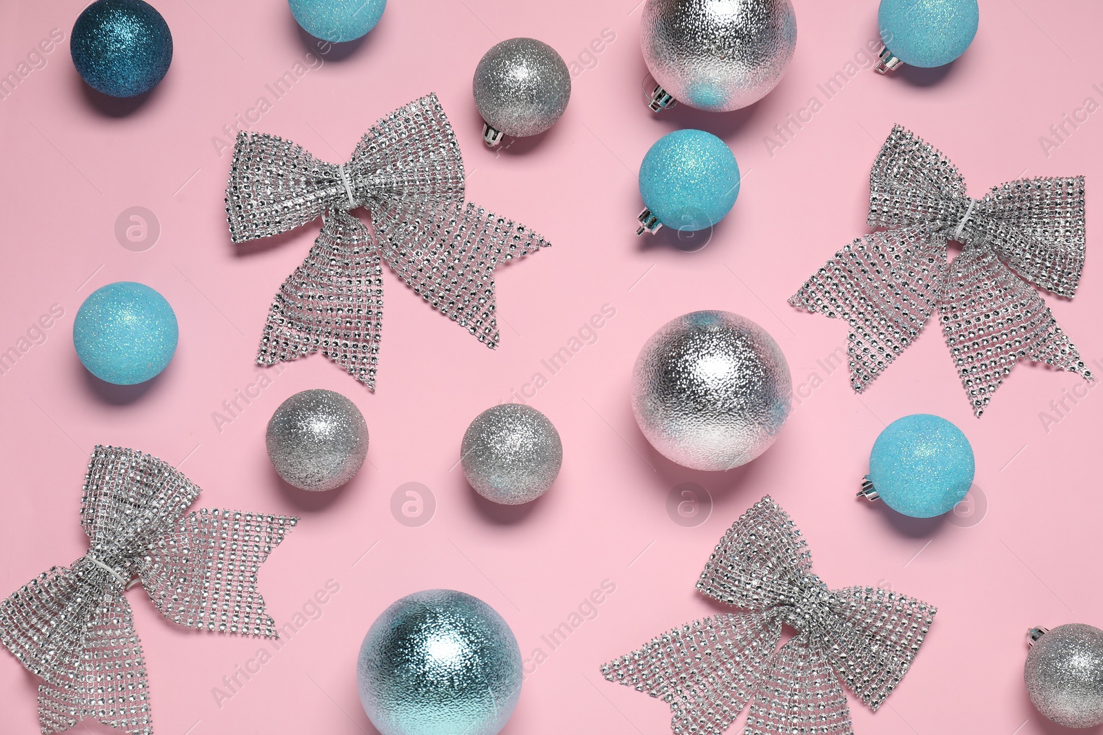 Photo of Flat lay composition with baubles and bows on pink background