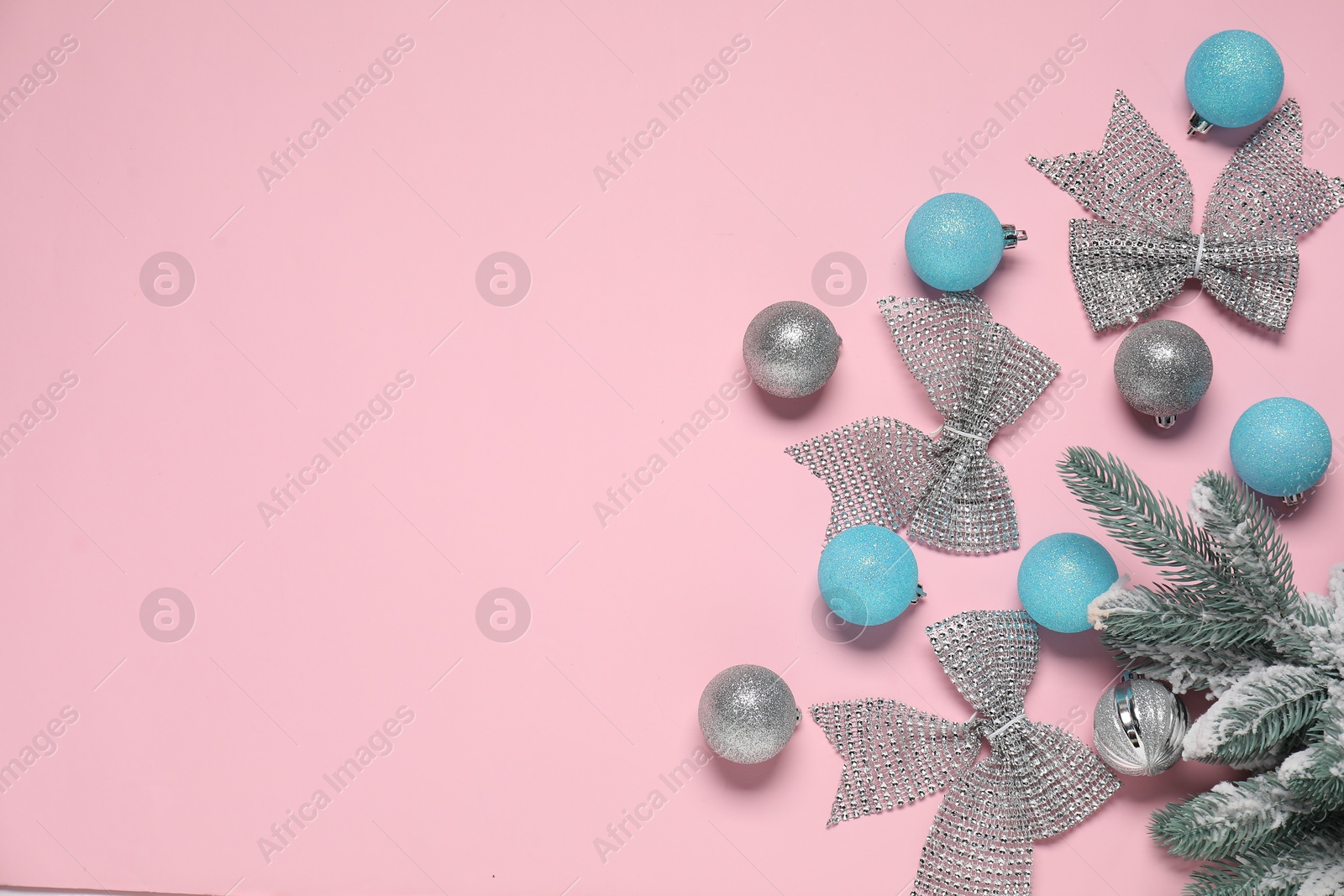 Photo of Flat lay composition with different Christmas decor on pink background. Space for text