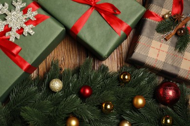 Photo of Different gift boxes and Christmas decor on wooden table, flat lay