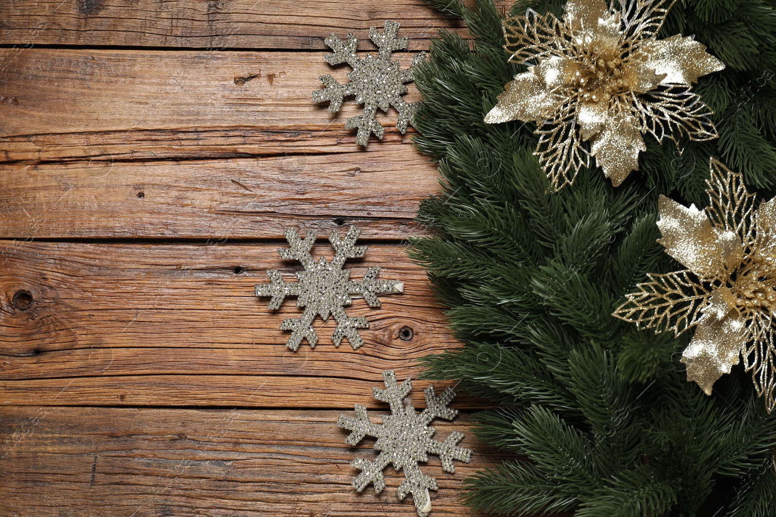 Photo of Fir tree branches and Christmas decor on wooden table, flat lay. Space for text