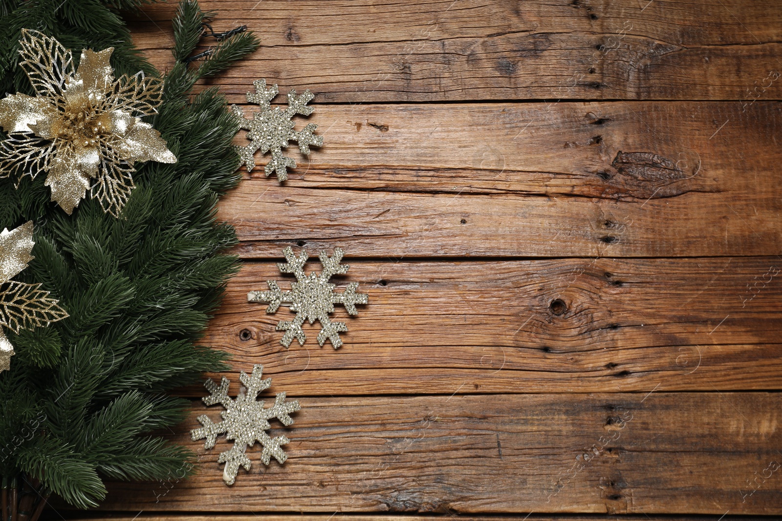 Photo of Fir tree branches and Christmas decor on wooden table, flat lay. Space for text