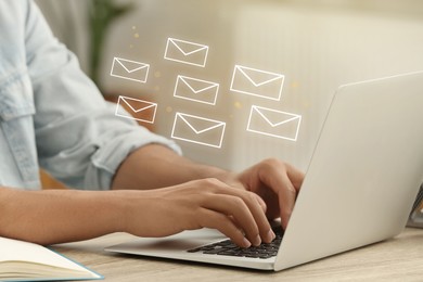 Image of Man using laptop at table, closeup. Illustrations of envelope over computer