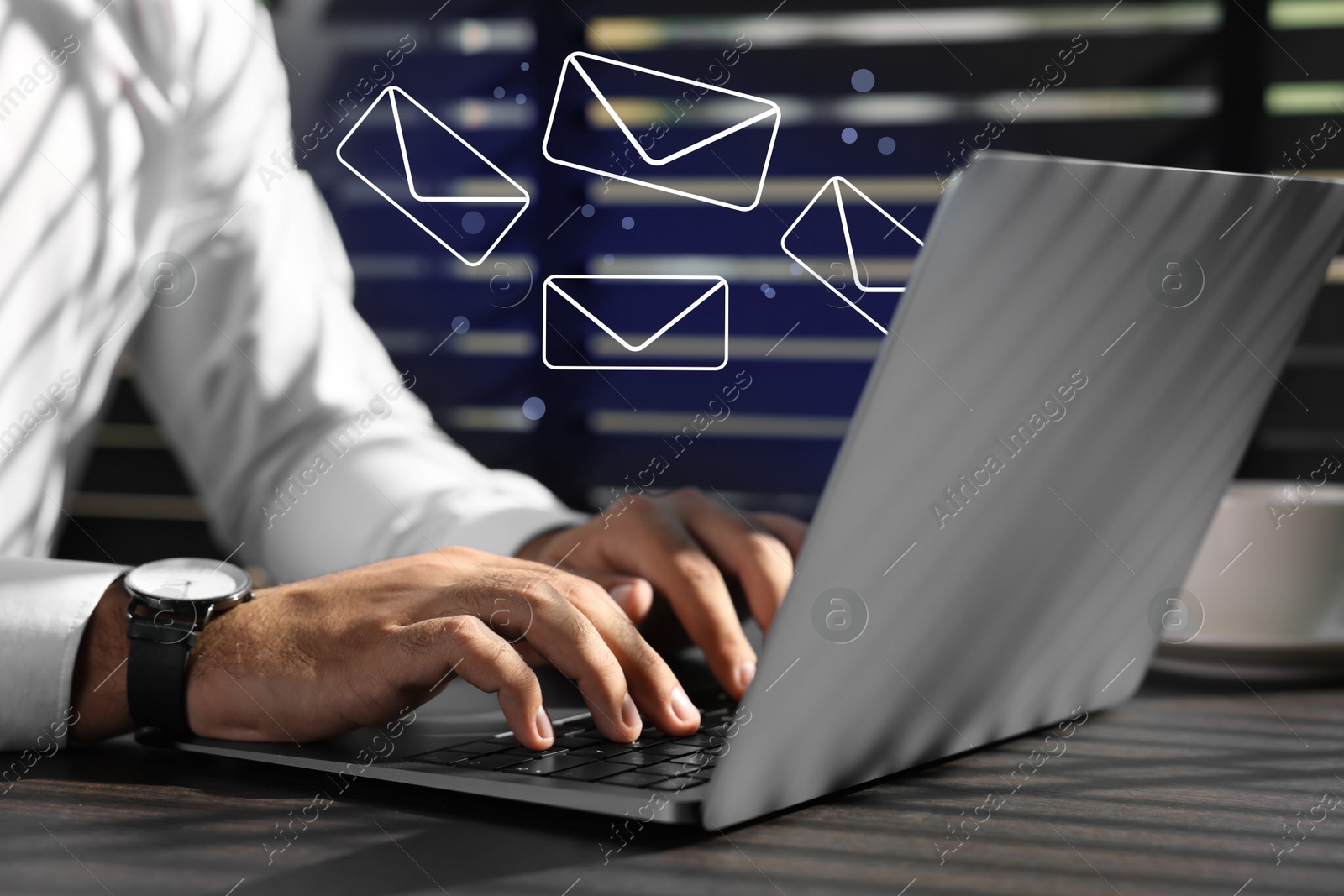 Image of Businessman using laptop at table, closeup. Illustrations of envelope over computer