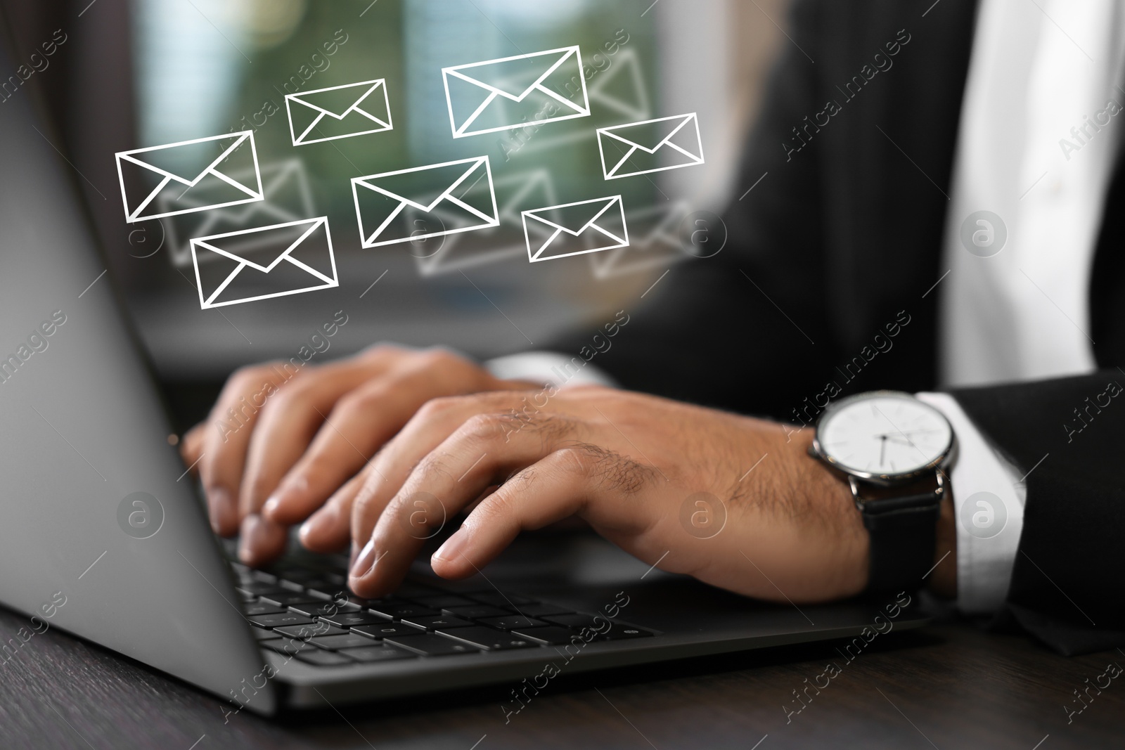 Image of Businessman using laptop at table, closeup. Illustrations of envelope over computer