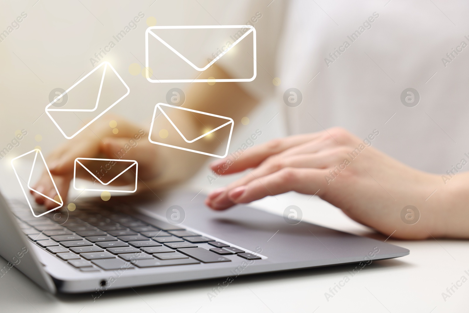 Image of Woman using laptop at table, closeup. Illustrations of envelope over computer