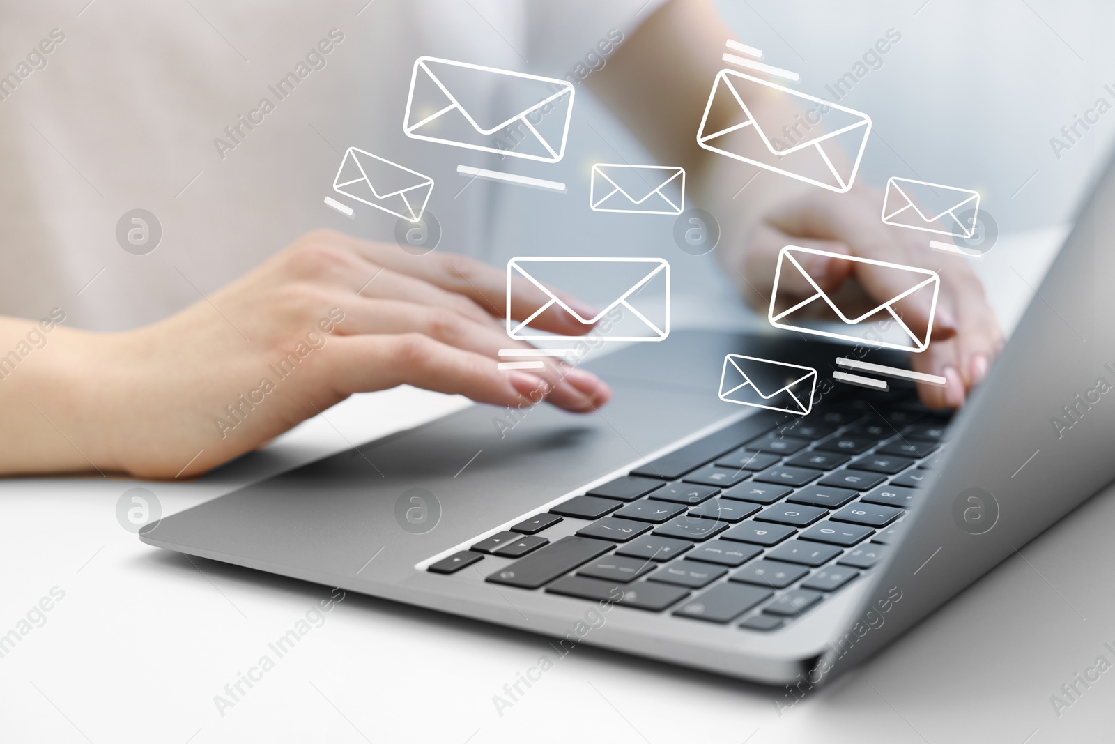 Image of Woman using laptop at table, closeup. Illustrations of envelope over computer