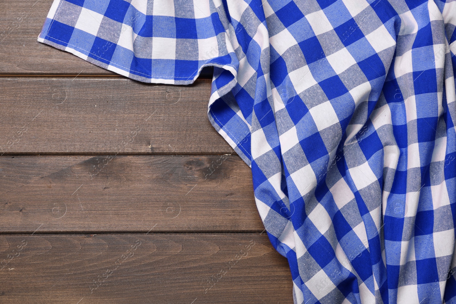 Image of Blue checkered gingham fabric on wooden table