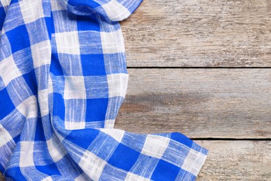 Image of Blue checkered gingham fabric on wooden table