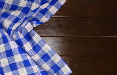 Image of Blue checkered gingham fabric on wooden table