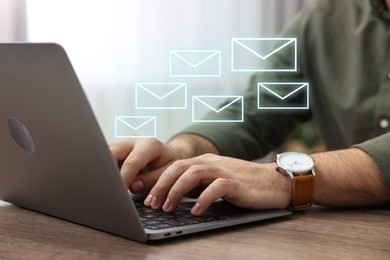 Image of Man using laptop at table, closeup. Illustrations of envelope over computer