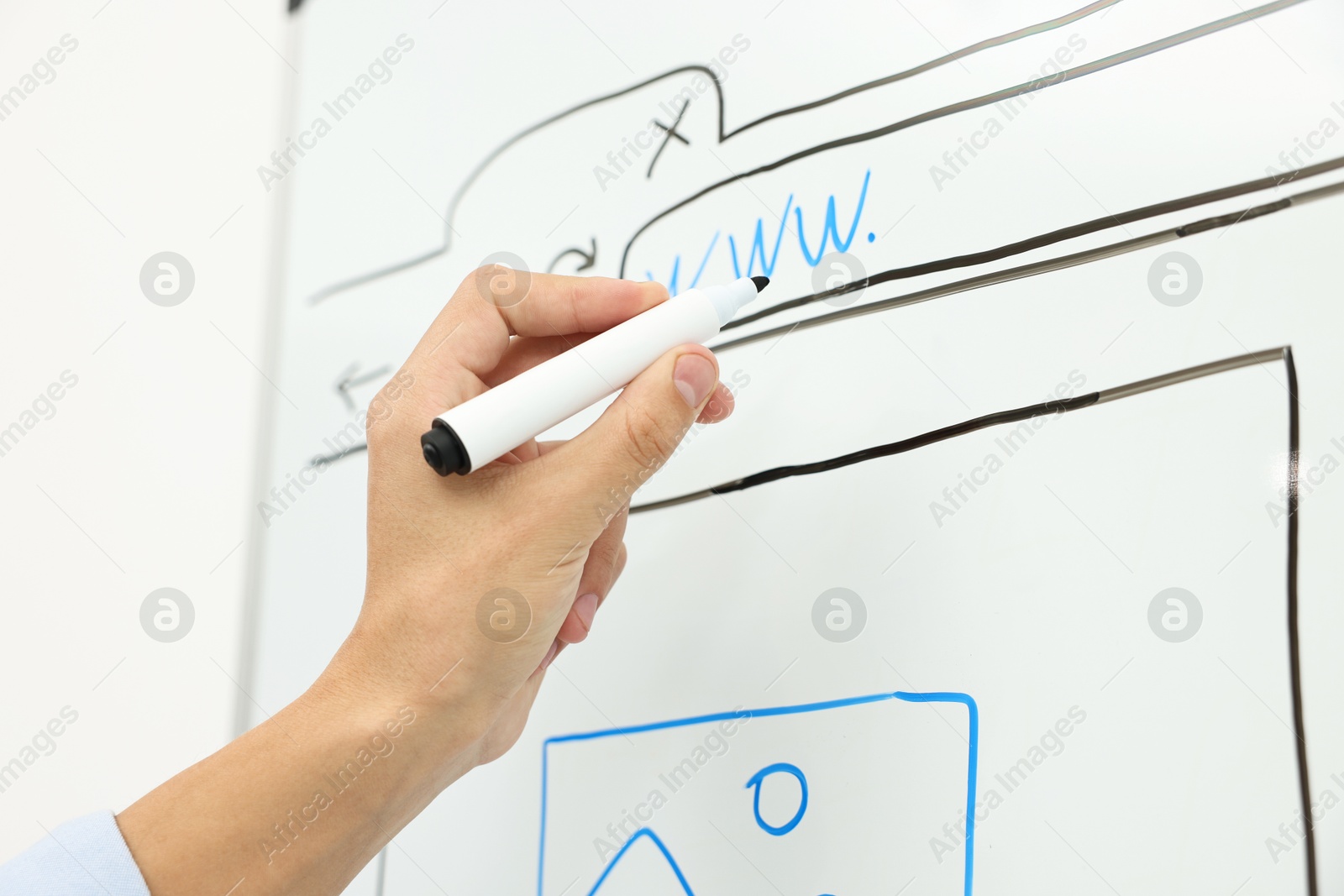 Photo of Developing UI design. Man drawing website wireframe on whiteboard indoors, closeup