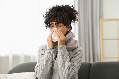 Cold symptom. Young woman with tissue at home