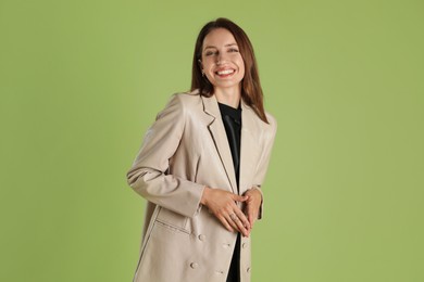 Photo of Beautiful woman in stylish beige jacket on olive background