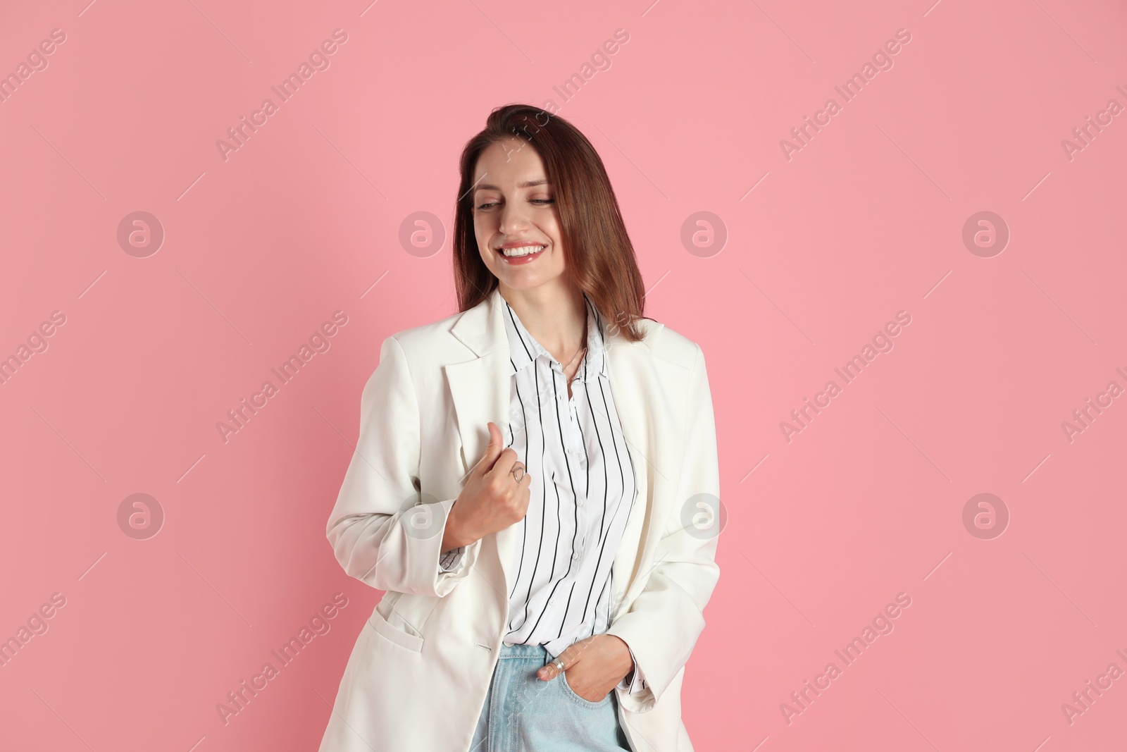 Photo of Beautiful woman in stylish white jacket on pink background