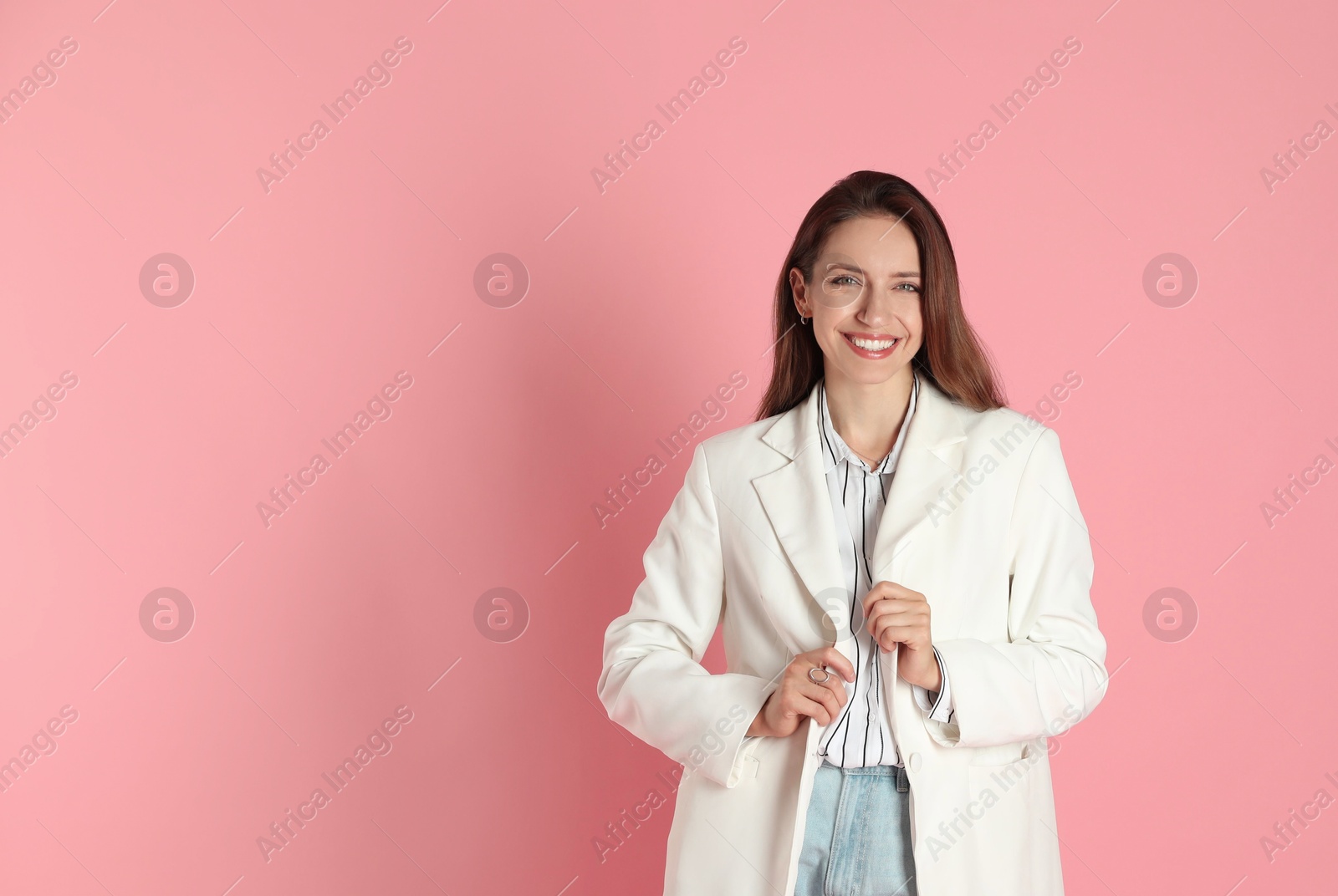 Photo of Beautiful woman in stylish white jacket on pink background, space for text