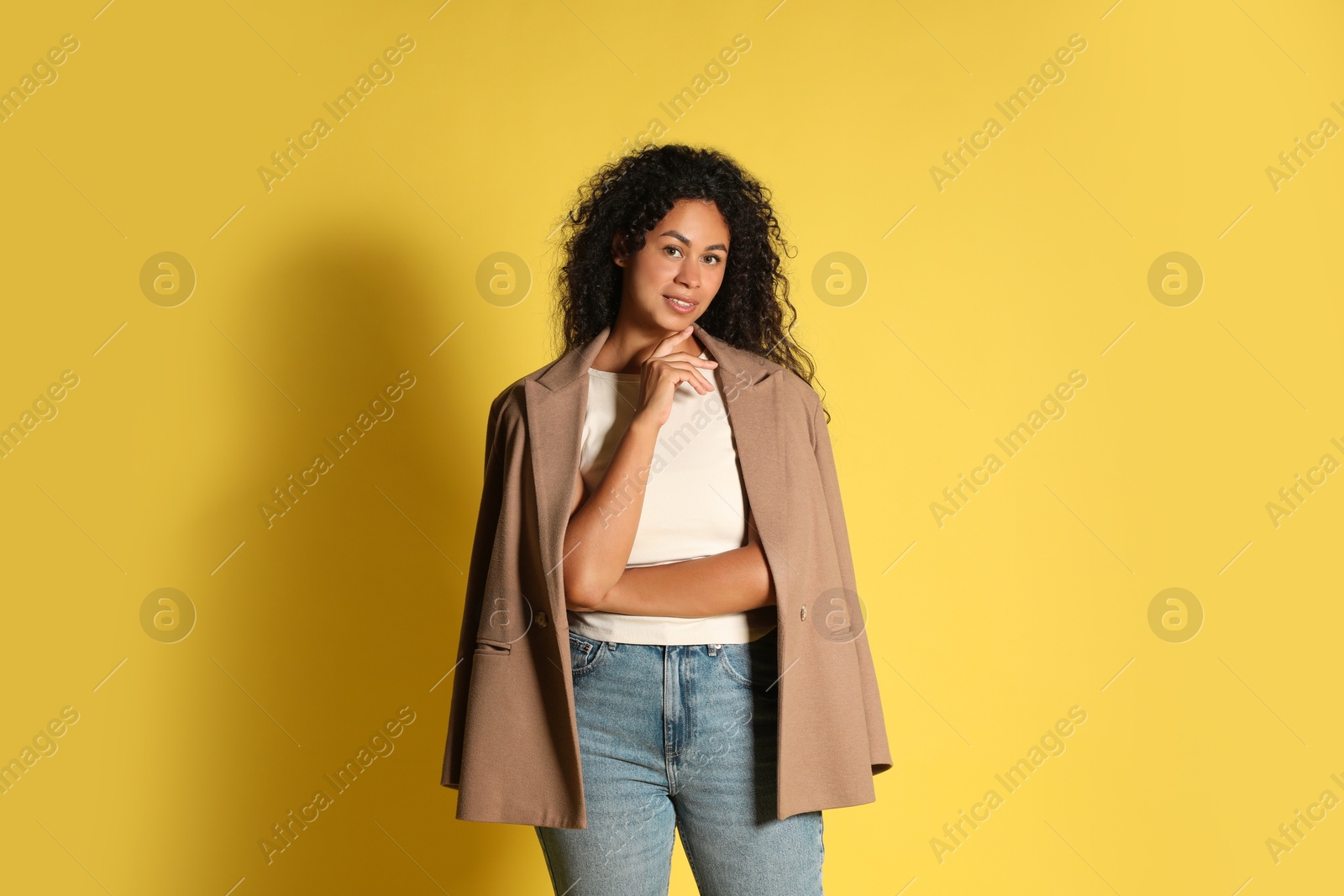 Photo of Beautiful woman with stylish jacket on yellow background