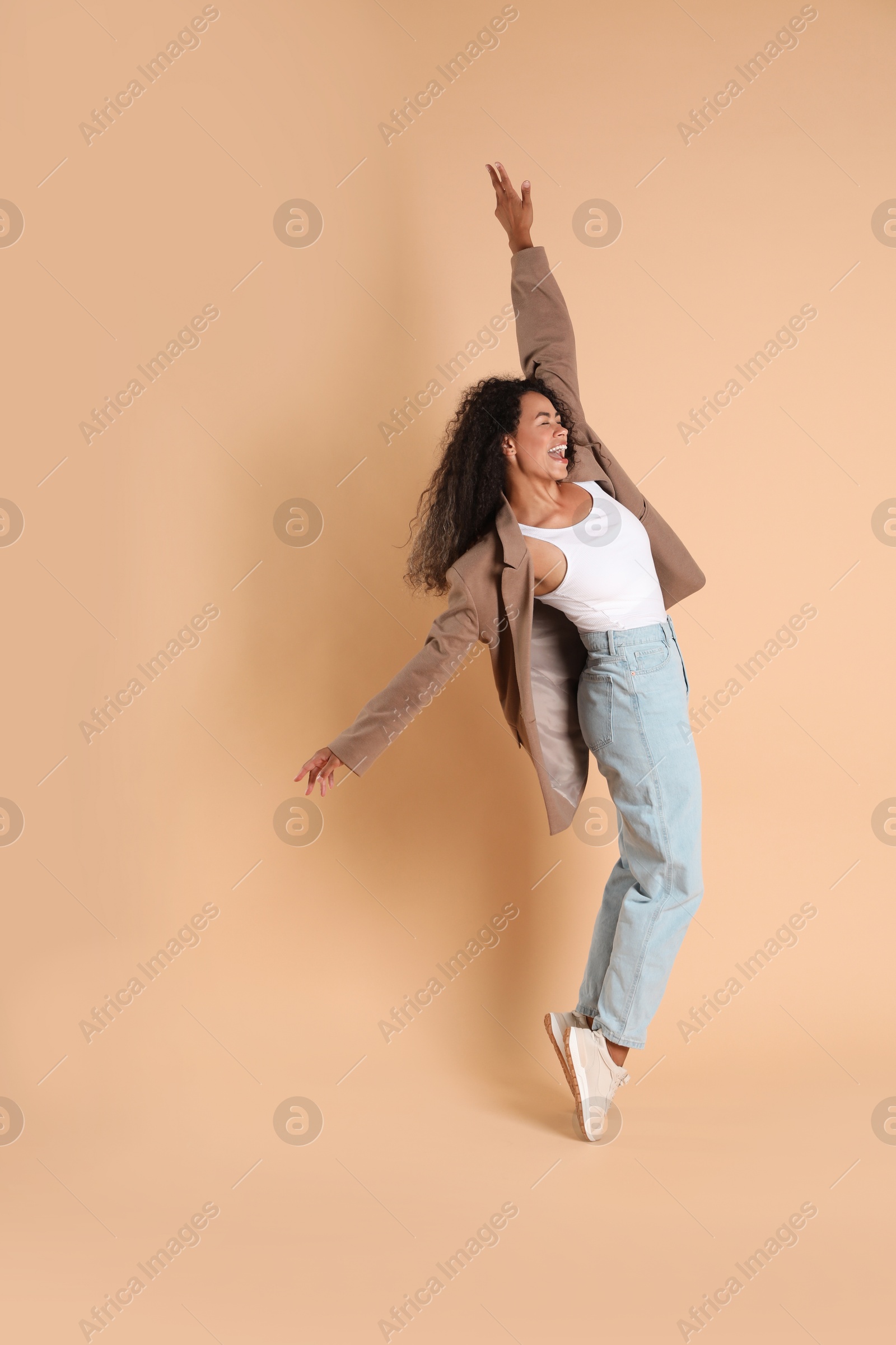 Photo of Beautiful woman in stylish jacket on beige background