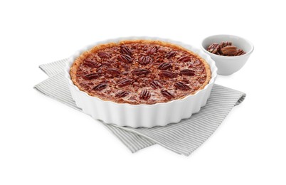 Photo of Delicious pecan pie in baking dish and bowl with fresh nuts isolated on white