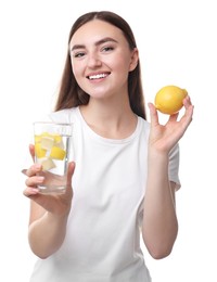 Woman with glass of lemon water and fruit on white background