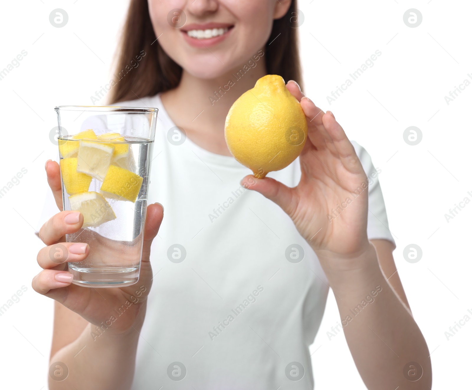 Photo of Woman with glass of lemon water and fruit on white background, closeup