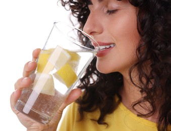 Photo of Woman drinking water with lemon on white background, closeup