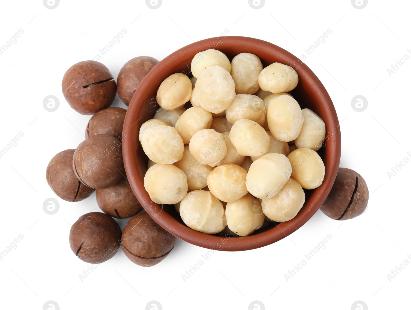 Photo of Macadamia nuts in bowl isolated on white, top view