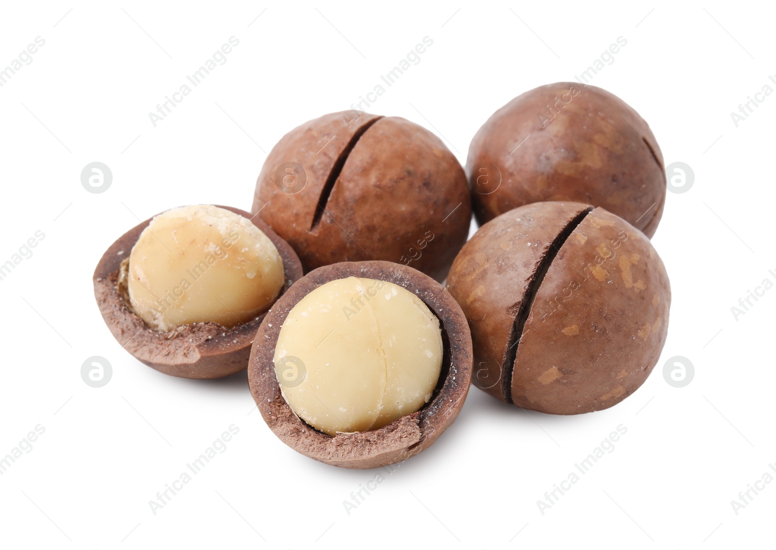 Photo of Macadamia nuts with shells isolated on white