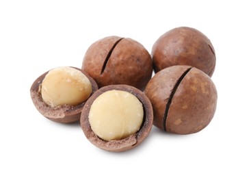 Photo of Macadamia nuts with shells isolated on white