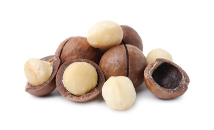 Photo of Macadamia nuts with shells isolated on white