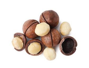 Photo of Macadamia nuts with shells isolated on white, top view