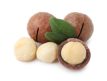 Photo of Macadamia nuts with shells isolated on white