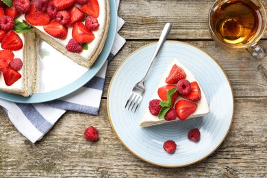 Photo of Tasty sponge cake with fresh berries and mint served on wooden table, flat lay