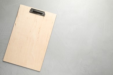 Photo of One clipboard on grey textured table, top view. Space for text