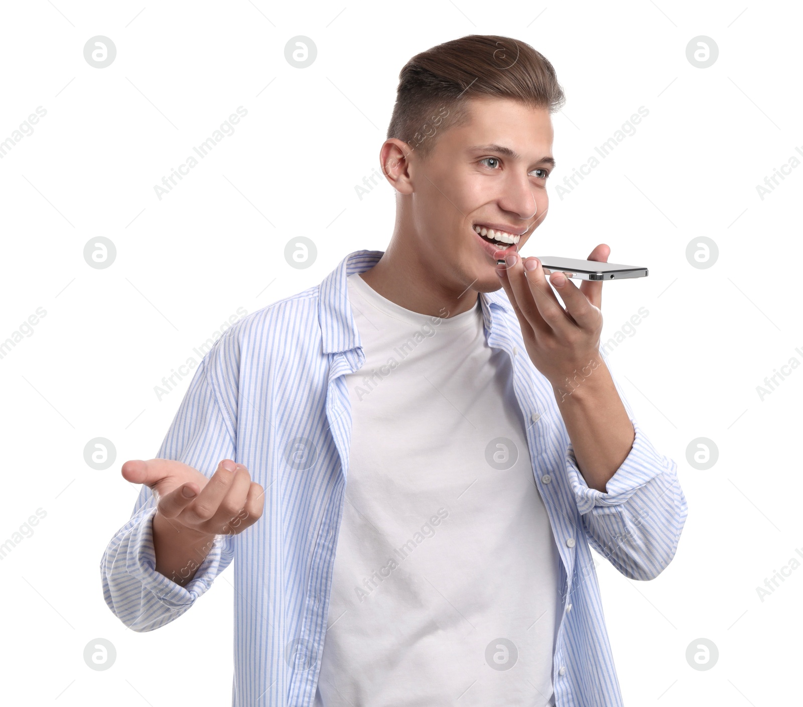 Photo of Young man recording voice message via smartphone on white background