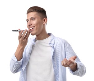 Photo of Young man recording voice message via smartphone on white background