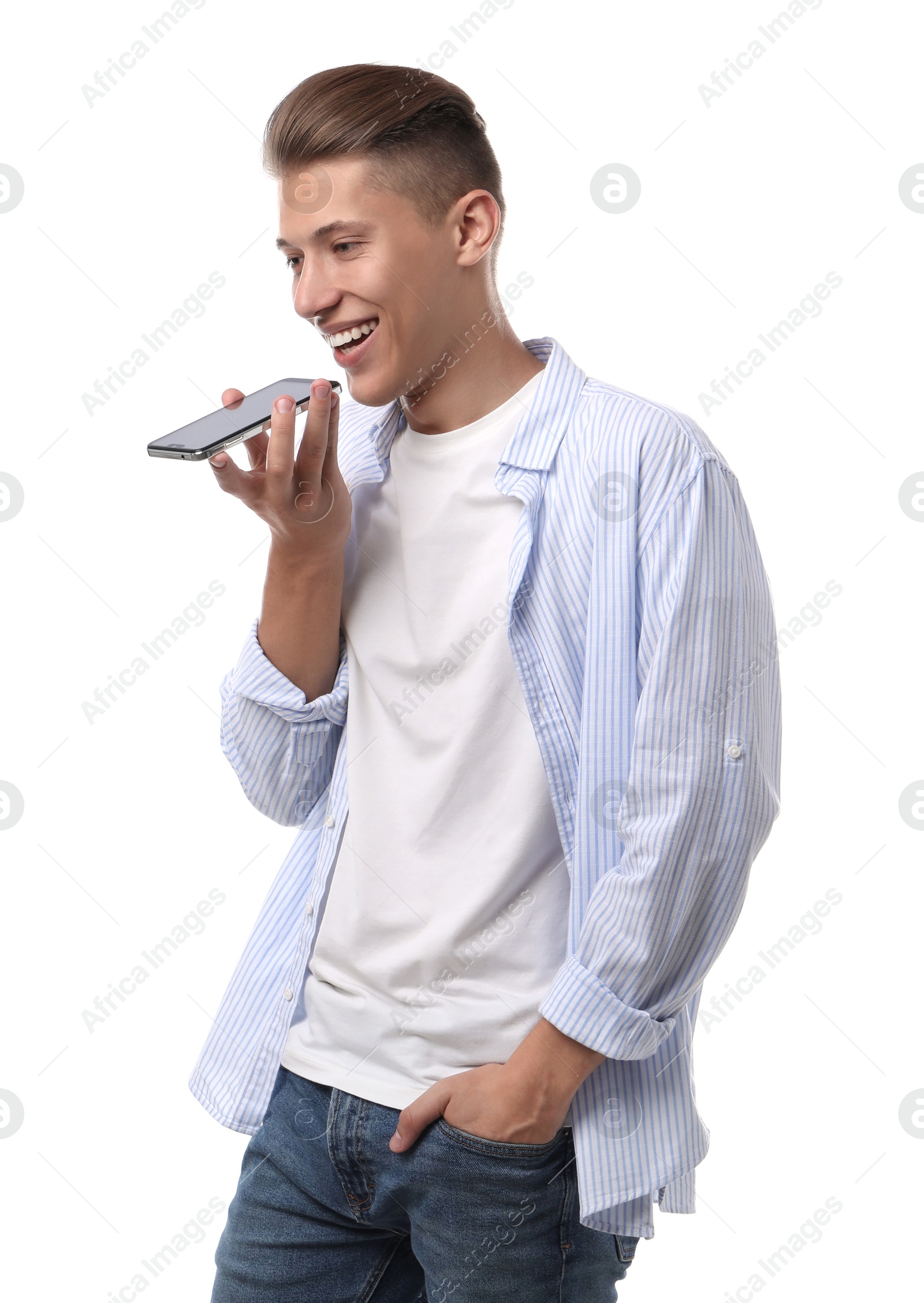 Photo of Young man recording voice message via smartphone on white background