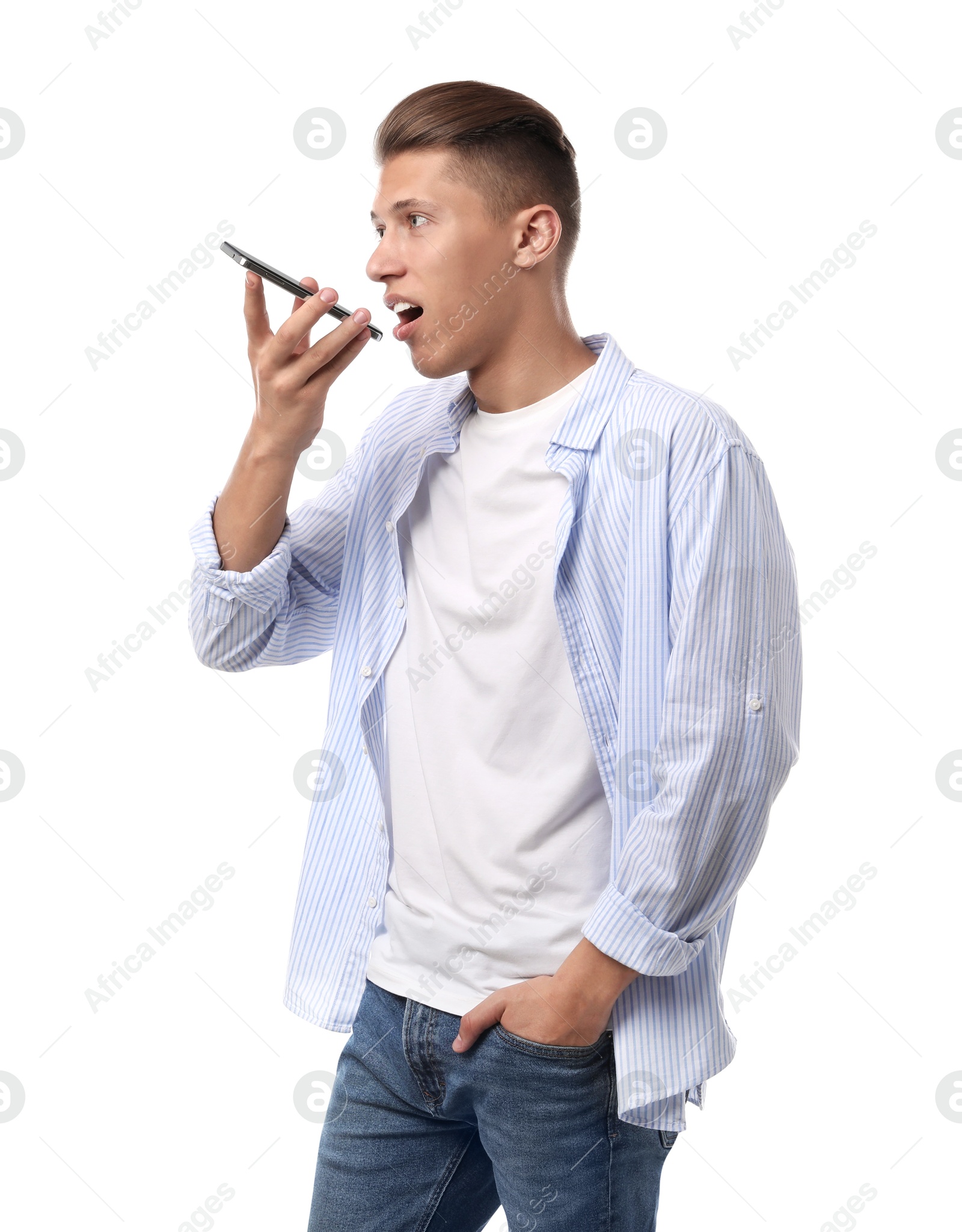 Photo of Young man recording voice message via smartphone on white background