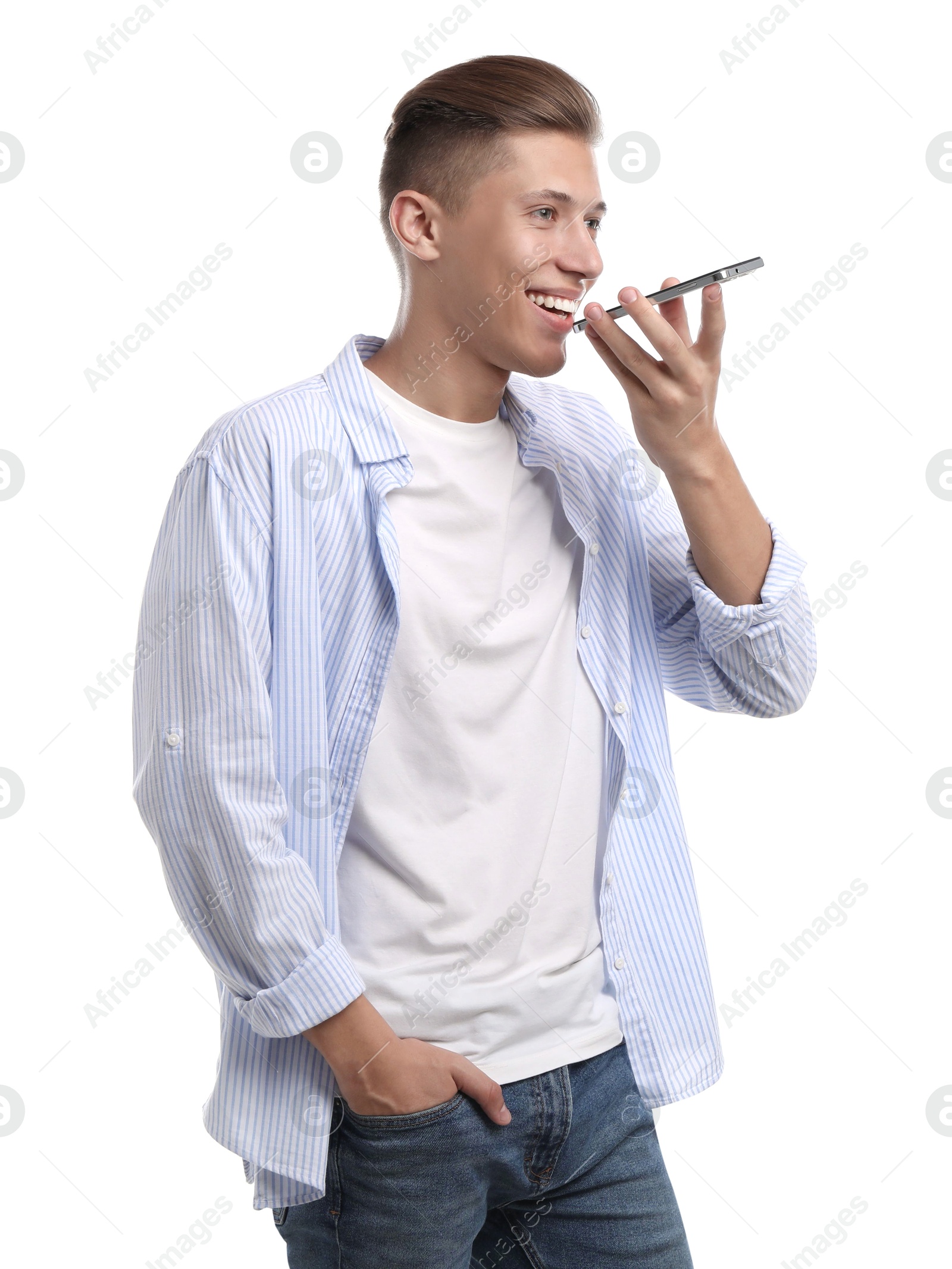 Photo of Young man recording voice message via smartphone on white background