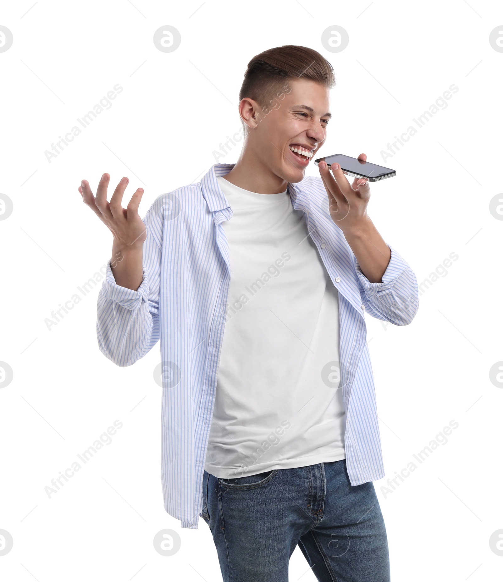 Photo of Young man recording voice message via smartphone on white background