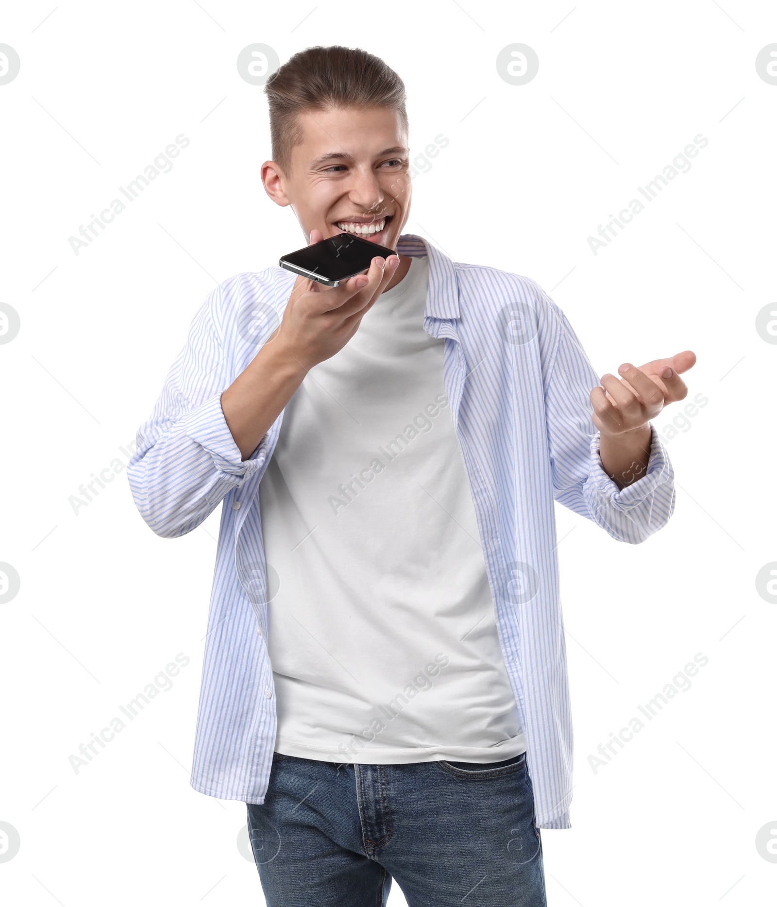 Photo of Young man recording voice message via smartphone on white background