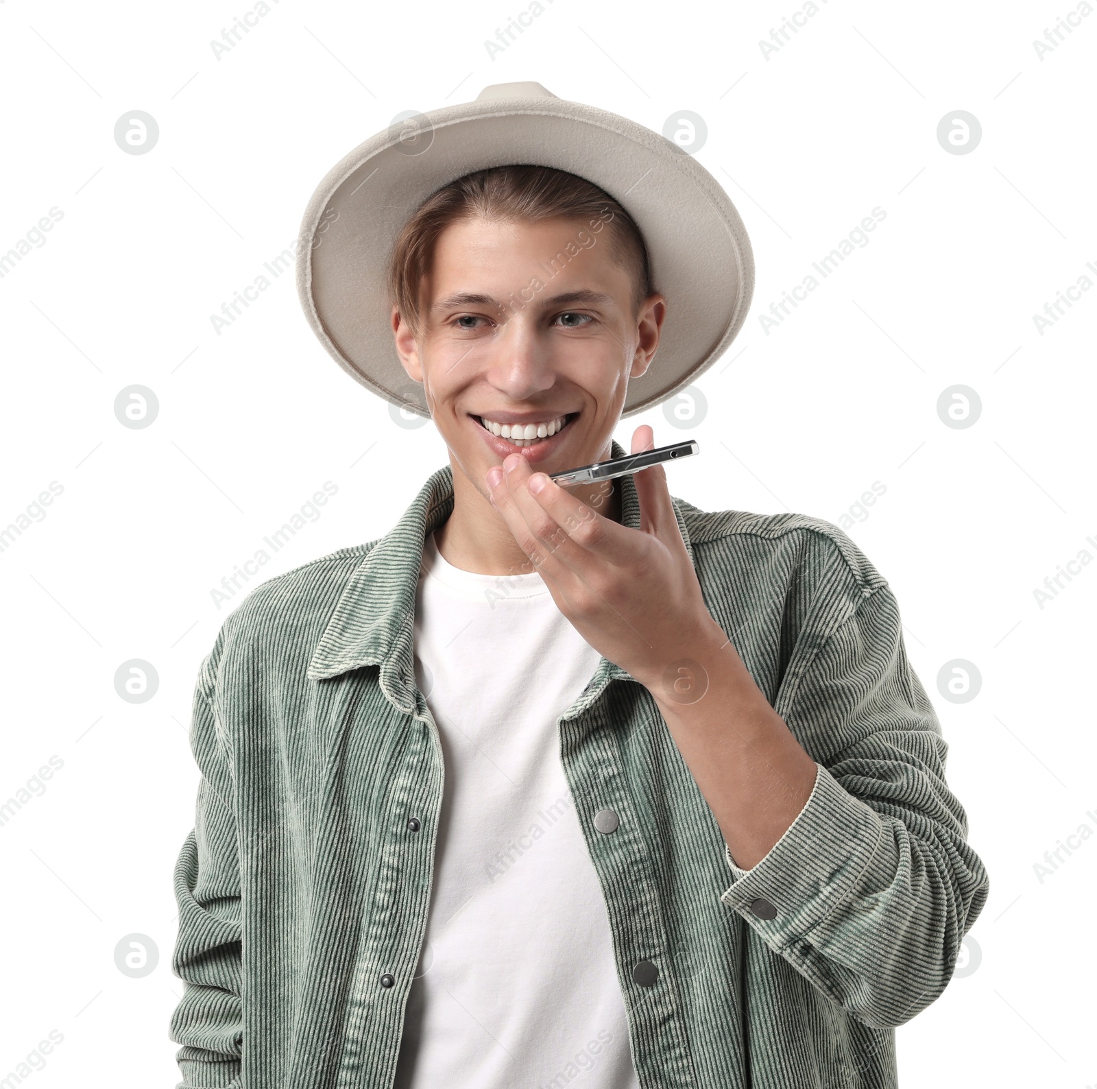 Photo of Young man in hat recording voice message via smartphone on white background