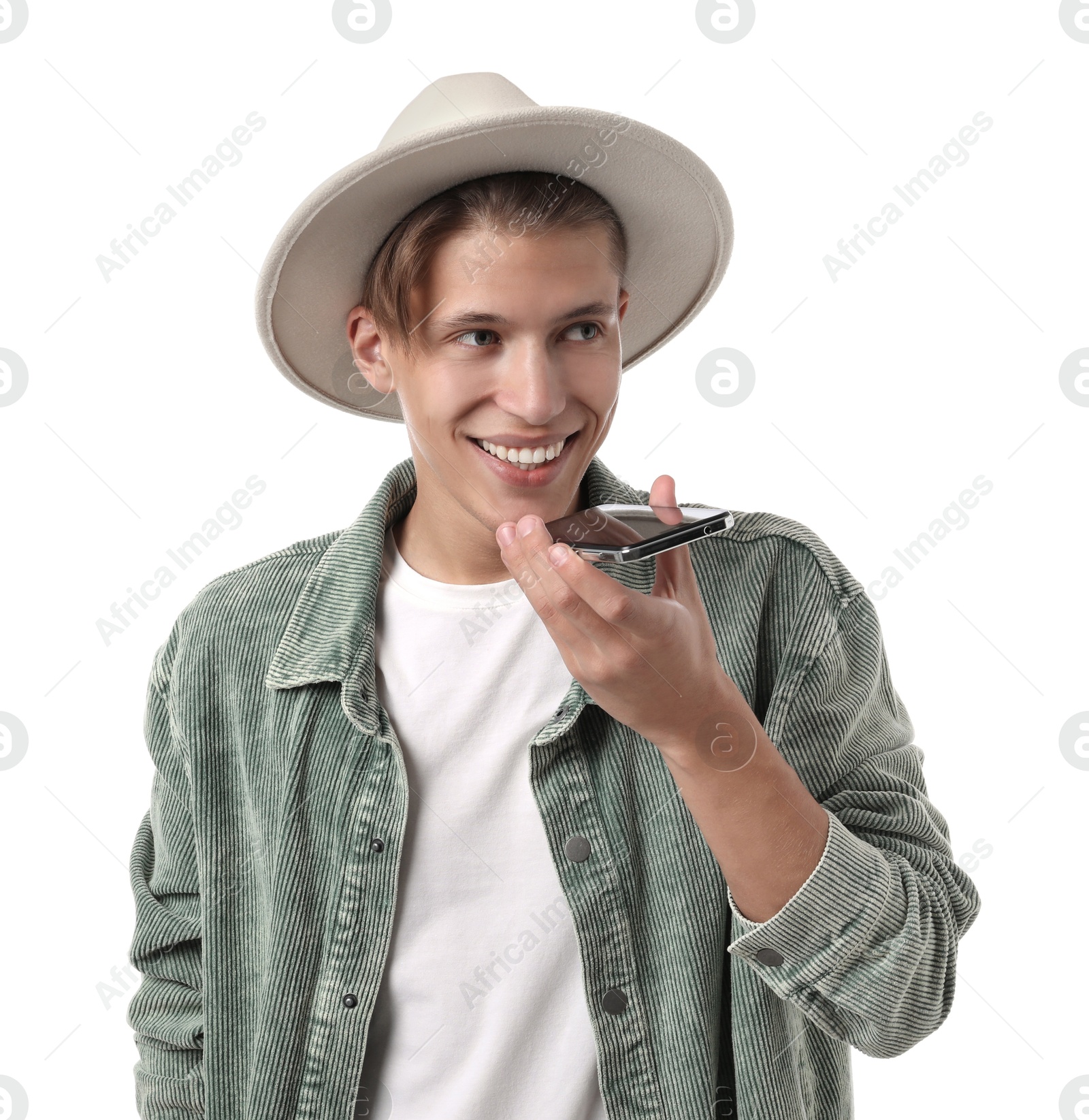 Photo of Young man in hat recording voice message via smartphone on white background