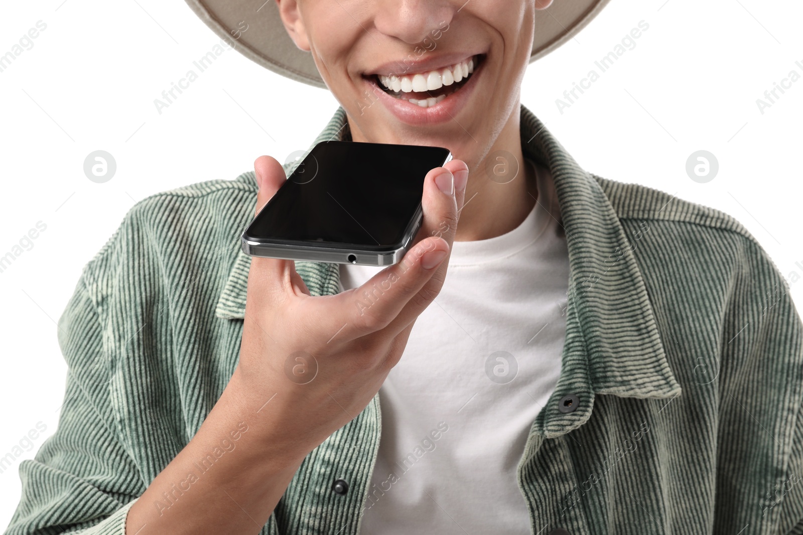 Photo of Young man recording voice message via smartphone on white background, closeup