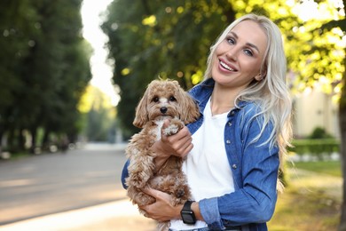 Photo of Beautiful young woman with cute dog in park