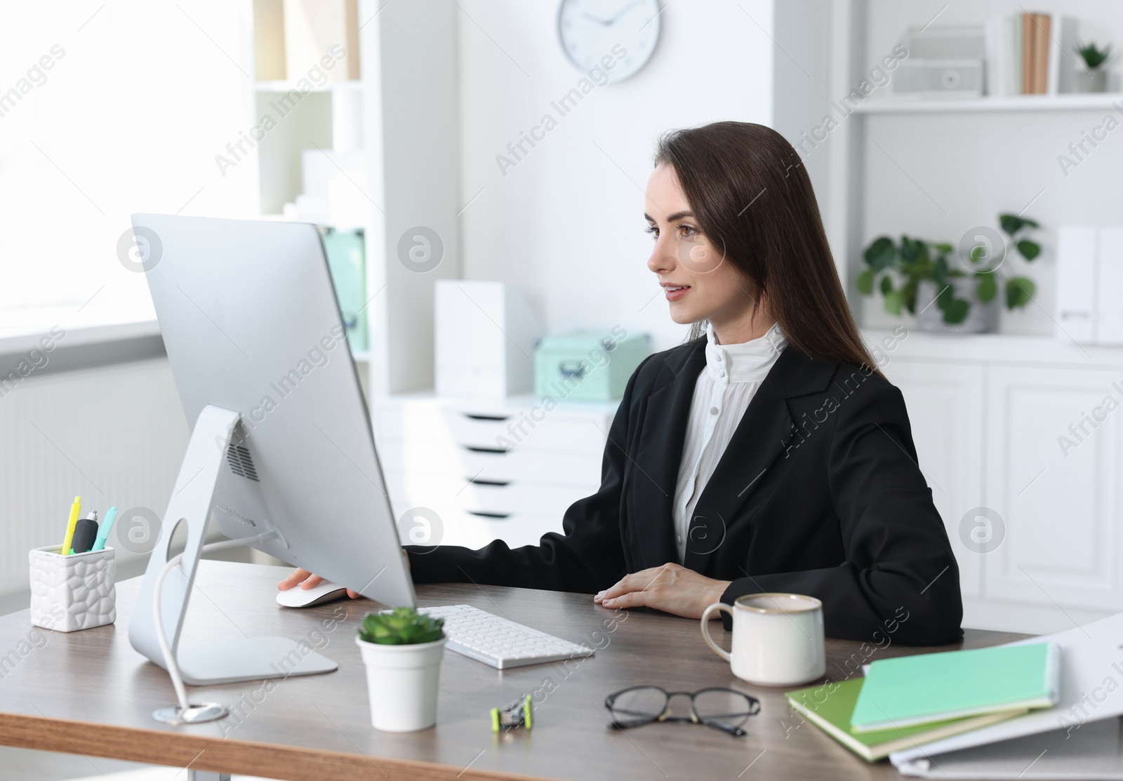 Photo of Beautiful businesswoman working at table in office