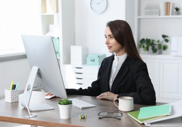 Beautiful businesswoman working at table in office