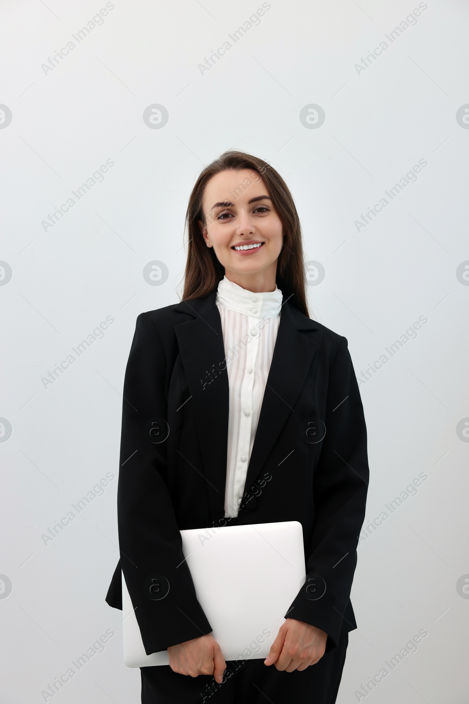 Photo of Portrait of smiling businesswoman with laptop on white background