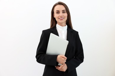 Photo of Portrait of smiling businesswoman with laptop on white background