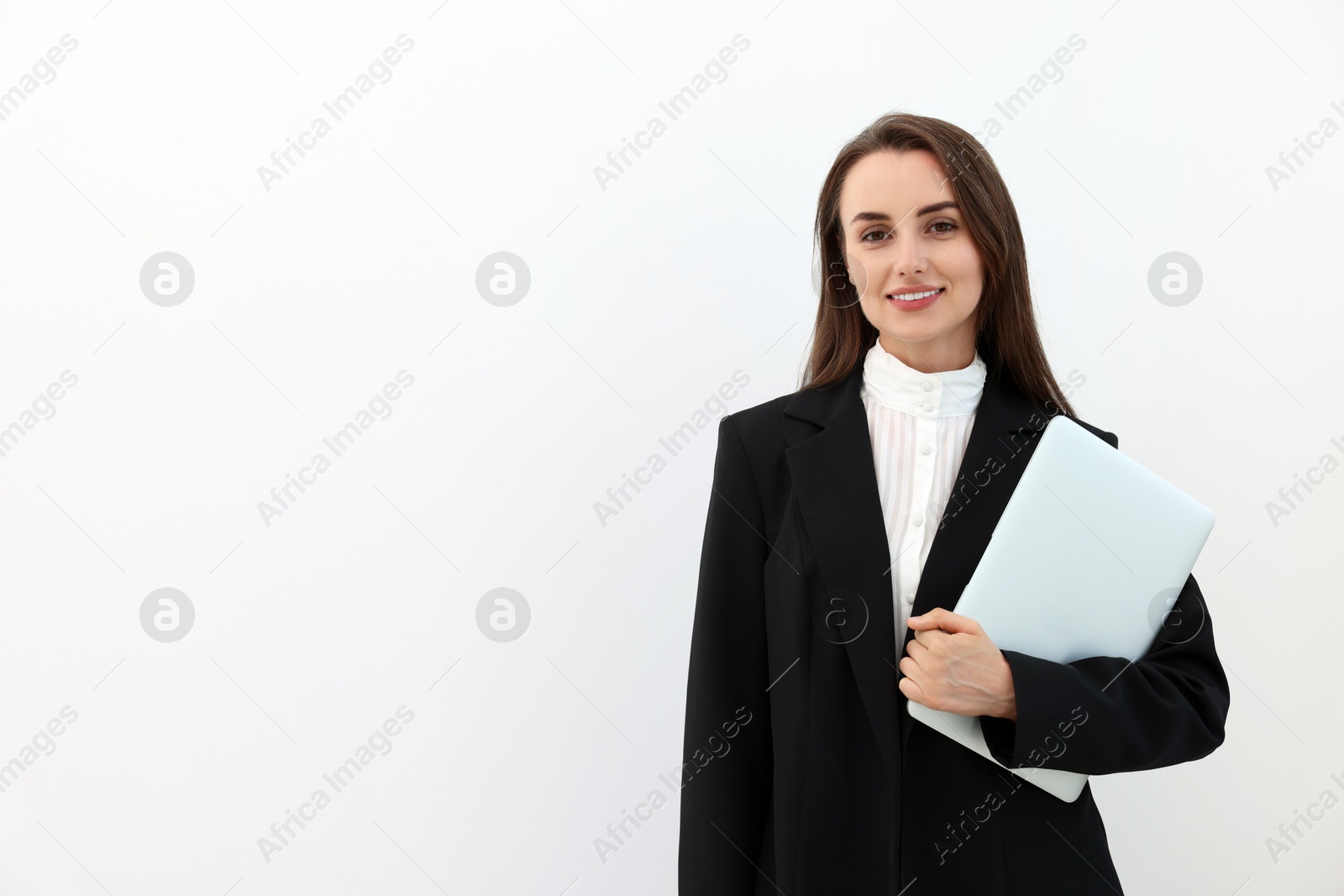 Photo of Portrait of smiling businesswoman with laptop on white background. Space for text