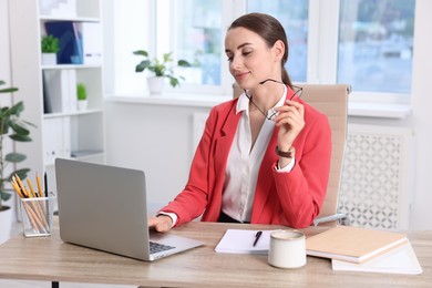 Beautiful businesswoman working at table in office